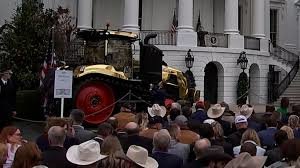 Trump Draws Attention at Event After Admiring Striking Gold Tractor Display